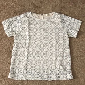 Patterned cream shirt with black stitching
